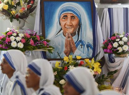 Indian Nuns from the Catholic Order of the Missionaries of Charity watch the live telecast of the canonisation of Mother Teresa from Rome, at the Mother House in Kolkata on September 4, 2016.