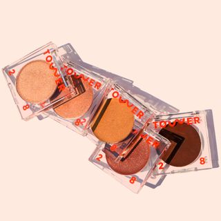 Tower 28’s Bronzino bronzers in 5 cream shades and clear square containers, featured in Wallpaper.com round-up of vegan make-up brands