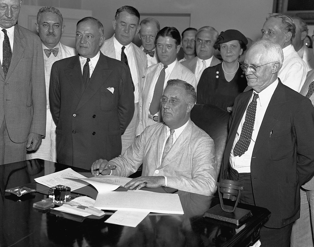 8/14/1935-Franklin Delano Roosevelt signing the Social Security Bill.