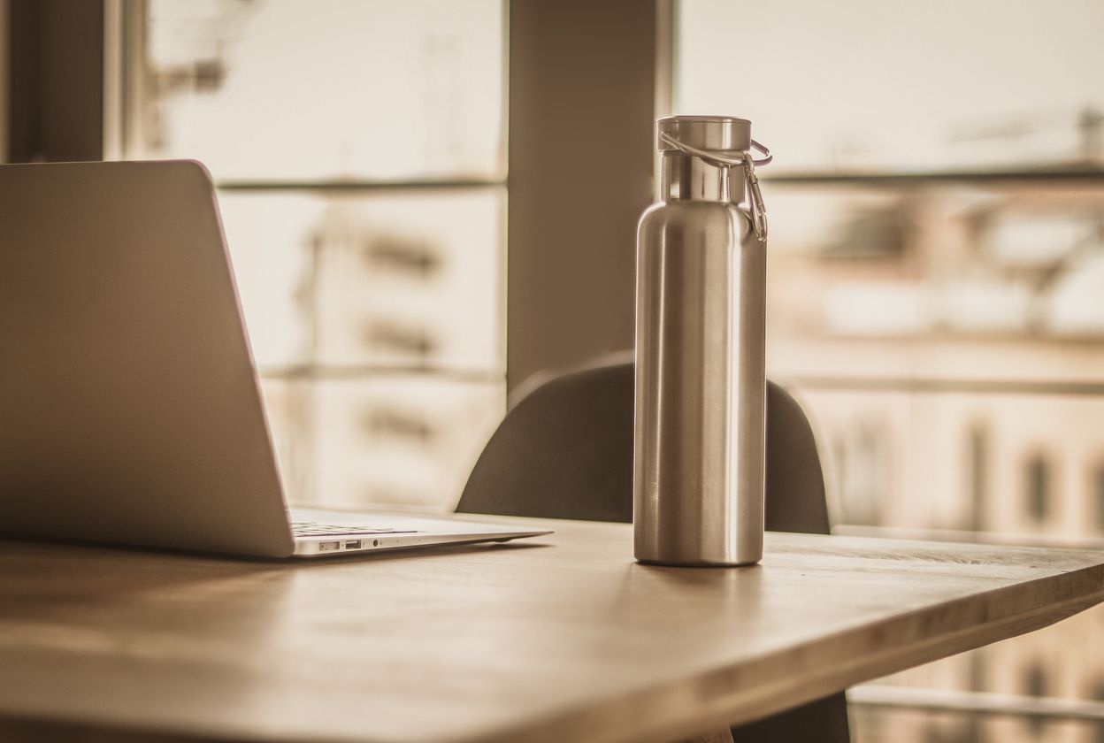 A water bottle on a desk.