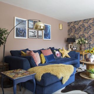 living room with blue sofa and wall pictures