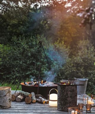 fire pit on a wooden deck with LED lanterns and glasses of drinks