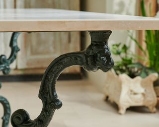 Close up of a marble table with black legs