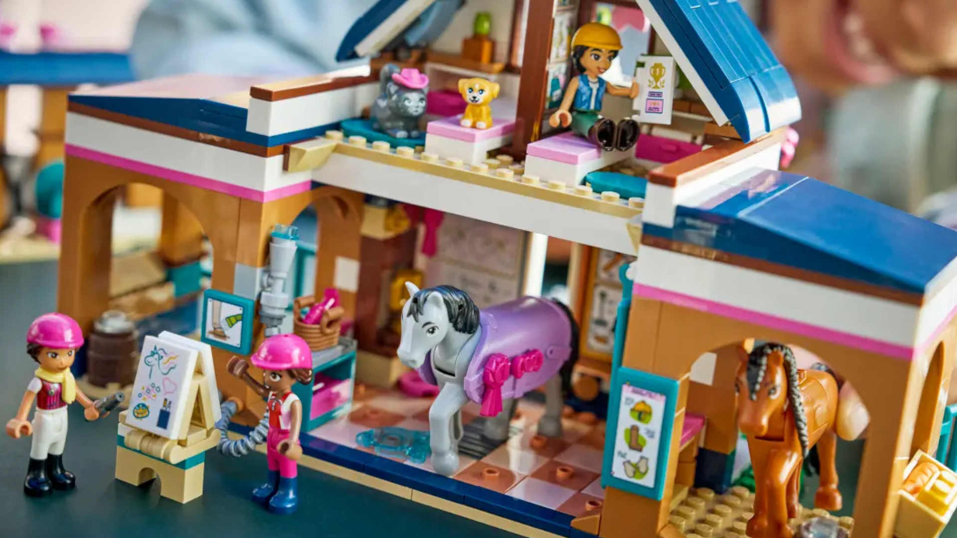 A Lego stables set and figures laid out