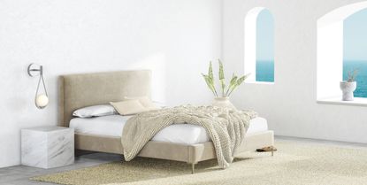 Saatva mattress on bed inside bright bedroom by coast