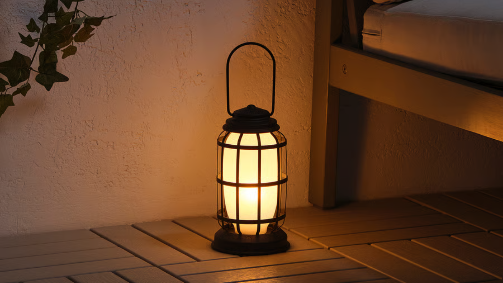 a small glowing lantern on the floor of a patio