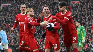 Alexis Mac Allister celebrates with his Liverpool team-mates after scoring against Manchester City in March 2024.