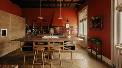 a kitchen with red walls and red marble countertops