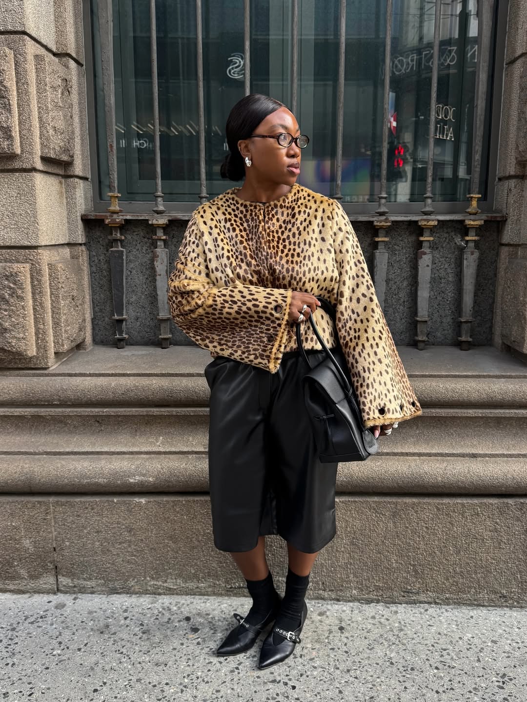 Nnenna in leather shorts and kitten heels