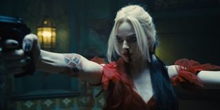 Margot Robbie arms raised with guns drawn in The Suicide Squad.