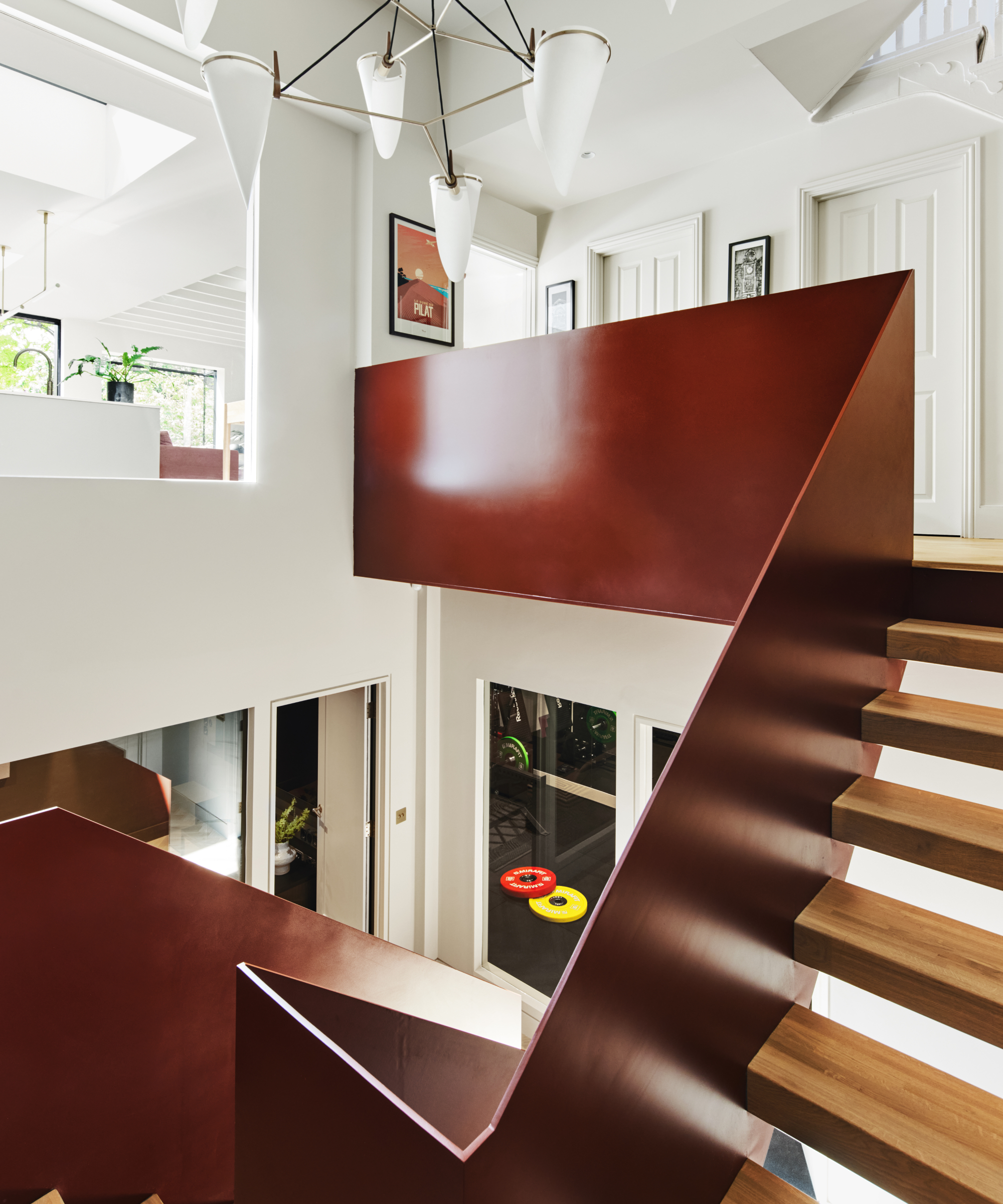 modern russet metal angular staircase leading down into basement conversion