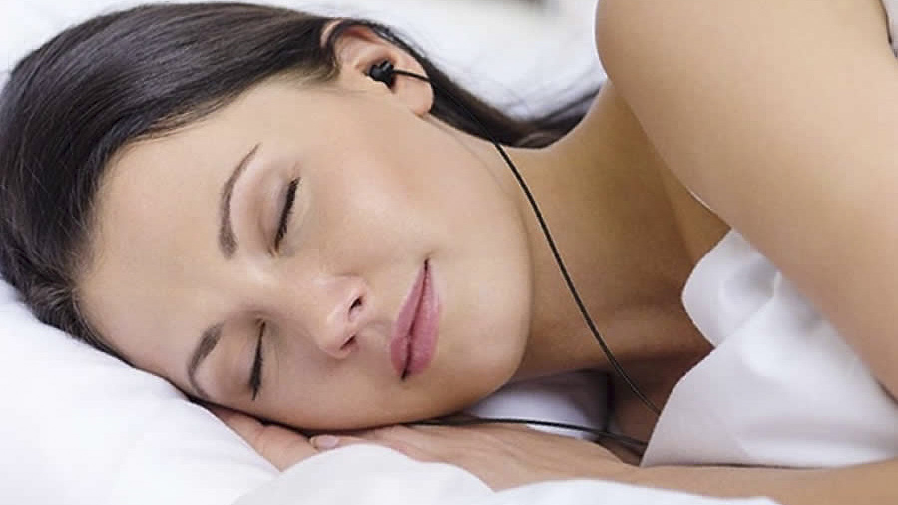 Woman lying down wearing Maxrock Sleep Earplugs.