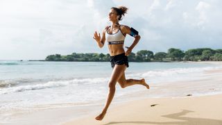 Black Friday sports bras for running deals: Image of a woman running on a beach