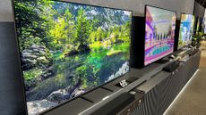 A range of Samsung TVs next to each other, in a long row