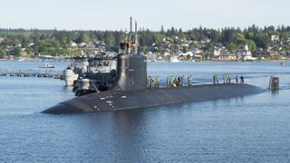 Photograph of submariners standing on top of the Seawolf-class fast-attack submarine USS Connecticut in the water at Naval Base Kitsap-Bremerton, Washington, May 7, 2018.