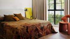 warm toned bedroom with tapestry quilt