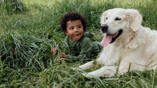 Interesting dog facts - child lying down with dog