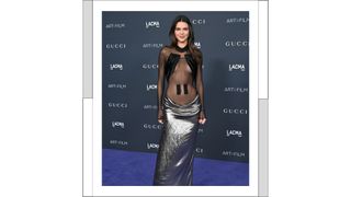 Kendall Jenner wears a black sheer top with a long silver skirt as she attends the 11th Annual LACMA Art + Film Gala at Los Angeles County Museum of Art on November 05, 2022 in Los Angeles, California.
