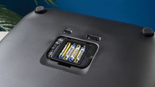 The underside of a Garmin Index S2 smart scale showing the battery compartment