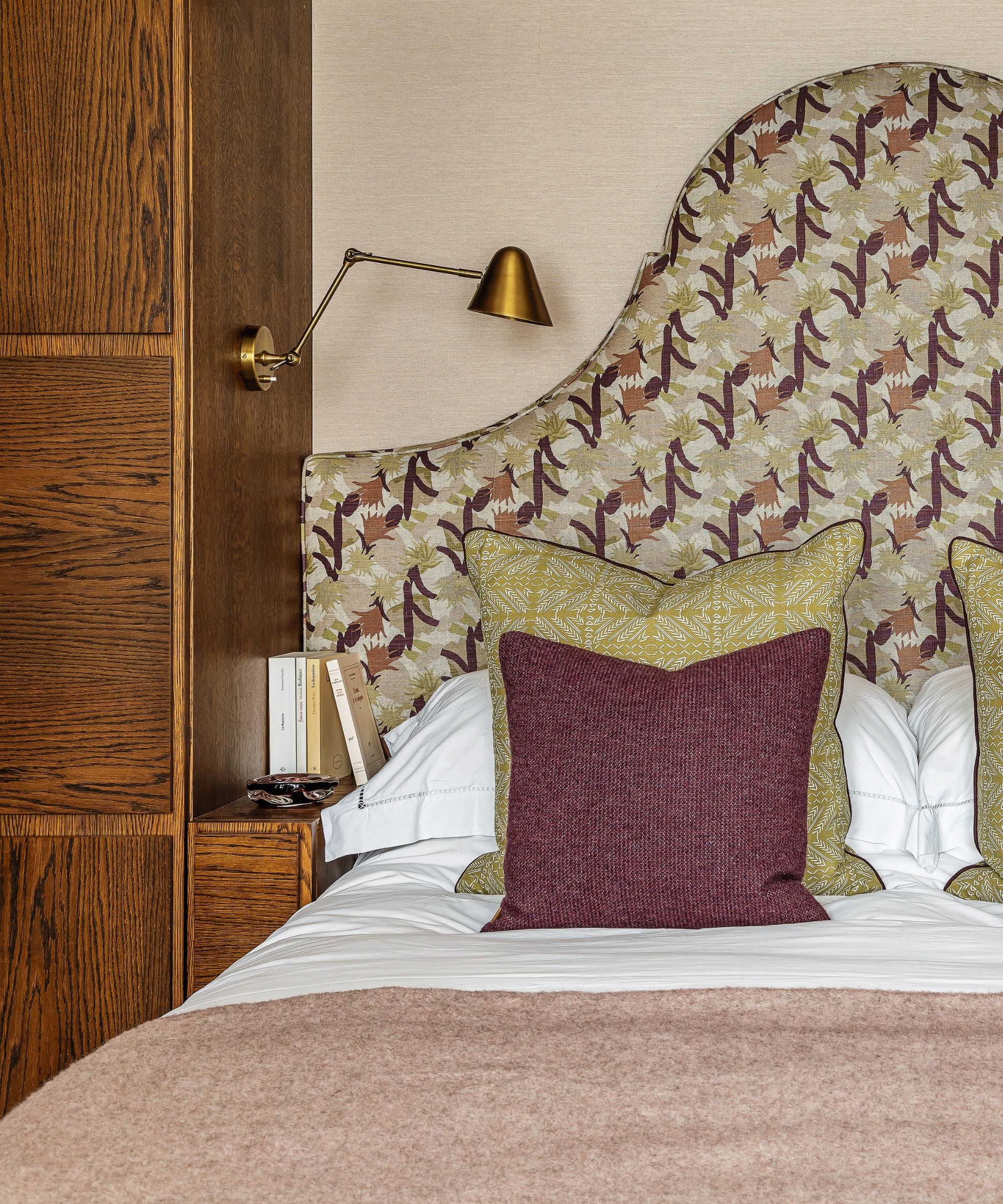 bed with patterned fabric headboard