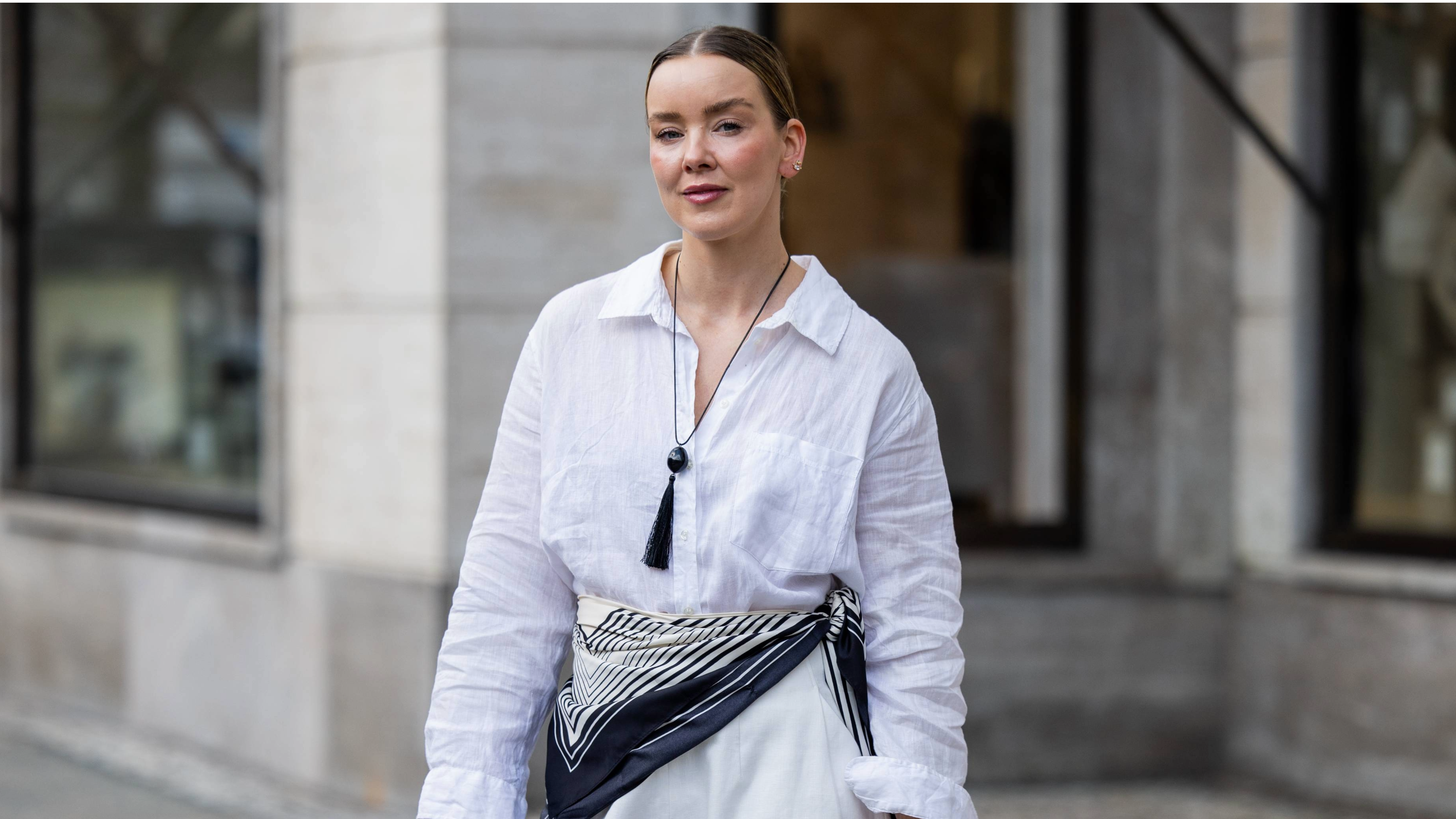 BERLIN, GERMANY - MARCH 24: Tina Haase wears white linen shirt, white barrel pants Meshki, striped scarf, tassel necklace Nakd, vintage Silver clutch bag on March 24, 2026 in Berlin, Germany. (Photo by Christian Vierig/Getty Images)