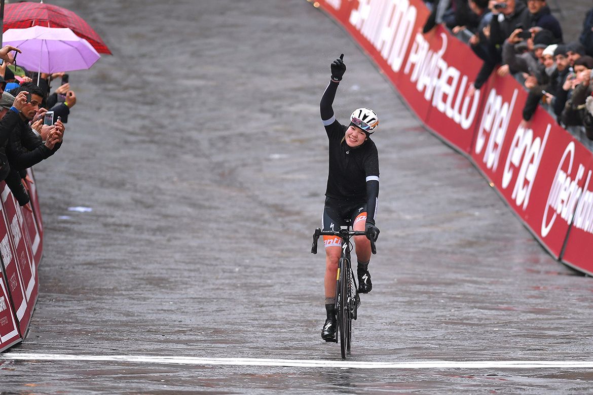 Anna van der Breggen raises her arm in celebration