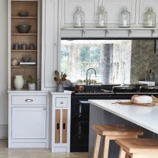 Light grey shaker kitchen with mirrored backsplash.