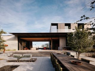 red rock house exterior with pool