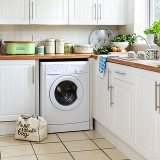 kitchen with white cabinets and washing machine