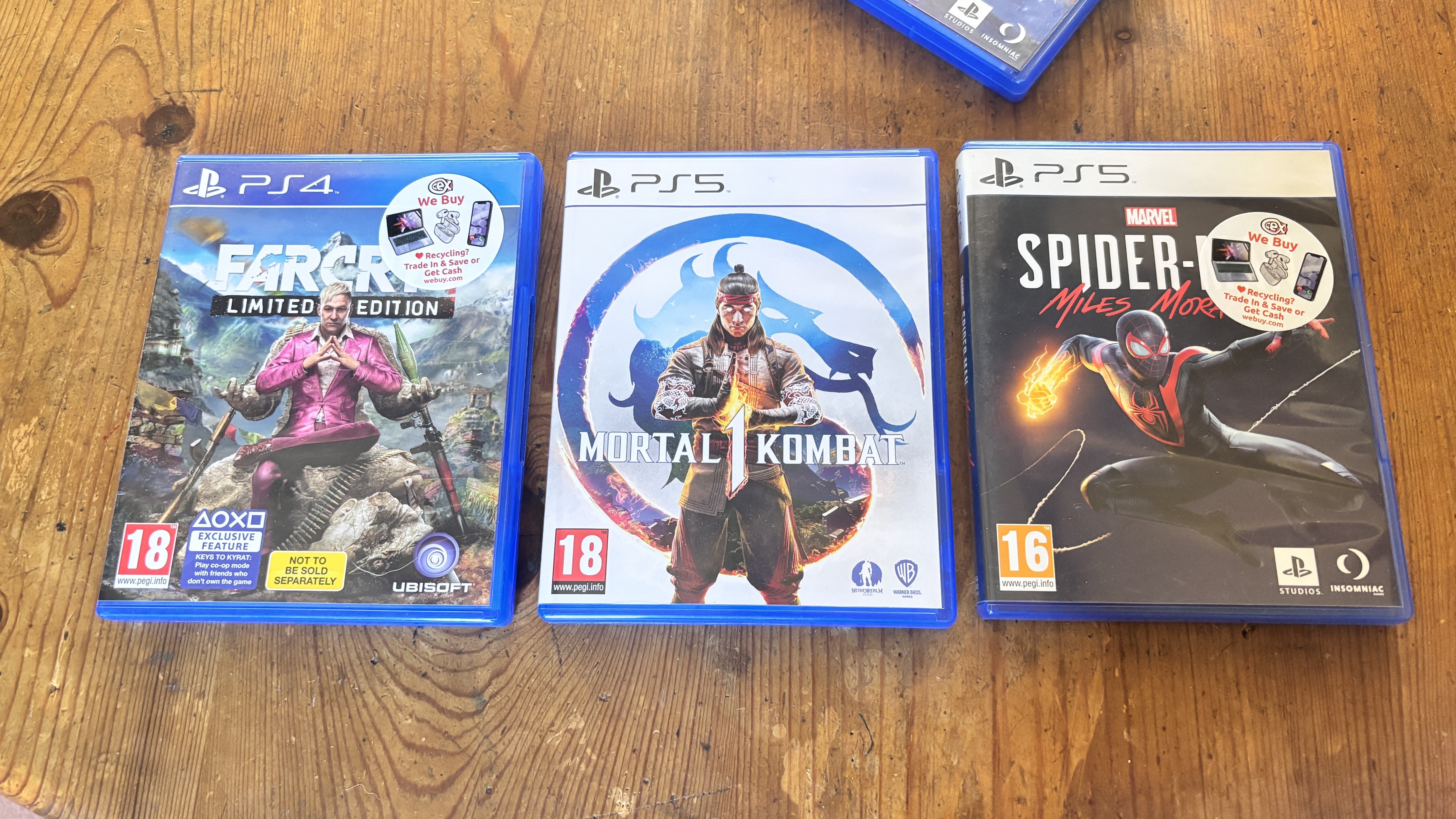 PlayStation 4 and 5 games on a wooden table 