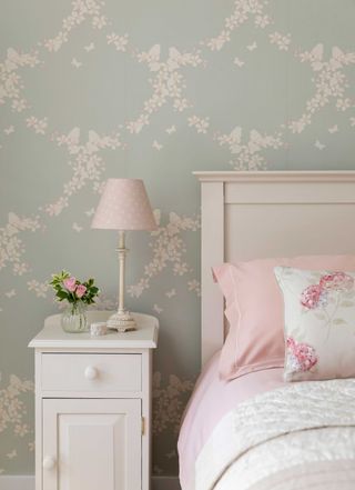 bedroom with pastel colourscheme and bedside table