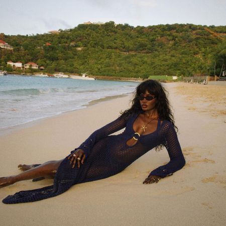@lefevrediary laying on the beach in st. barts in navy crochet cover-up dress by monday swimwear