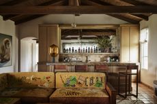 a home bar with a sofa that has decorative motifs on