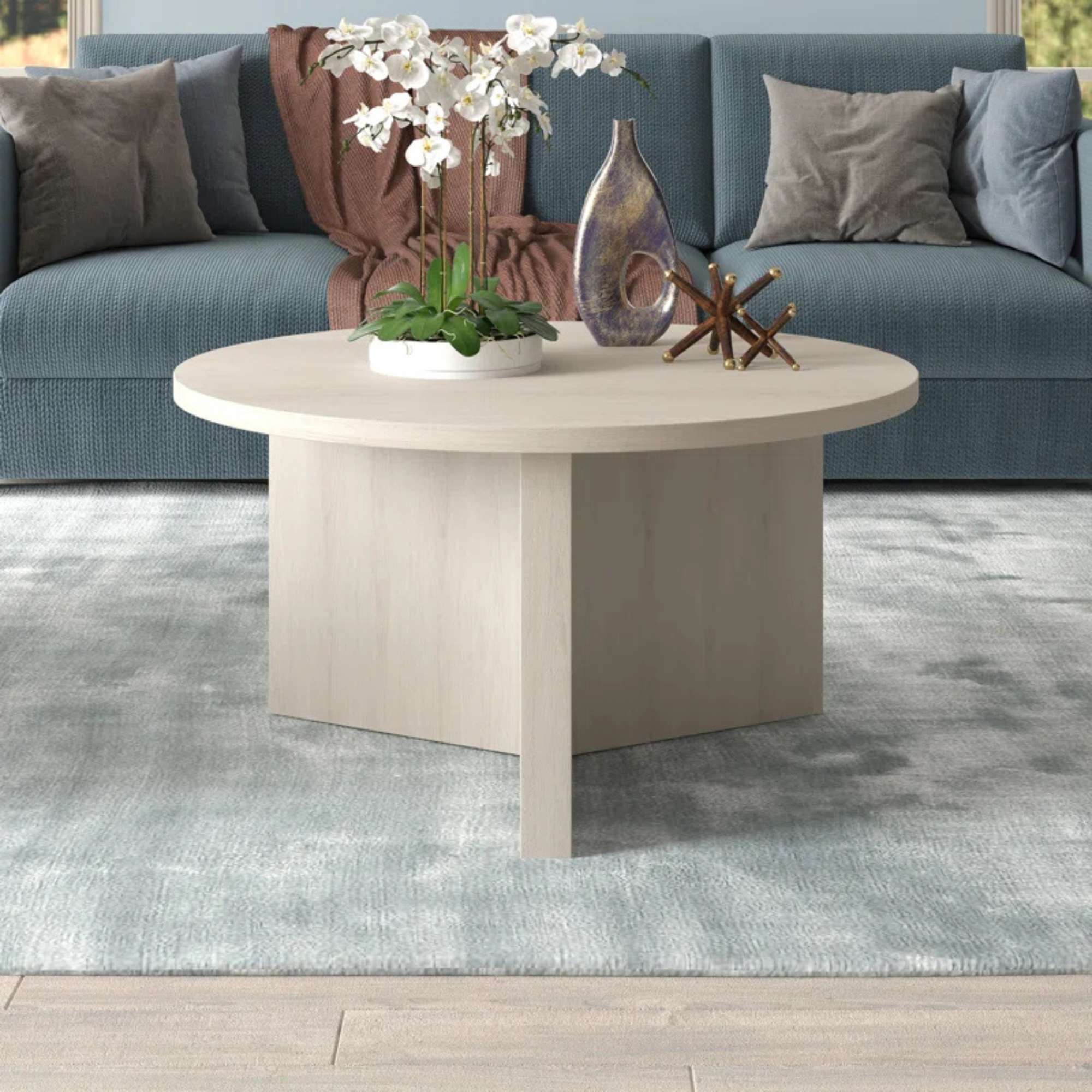 A beige, wood, circular coffee table
