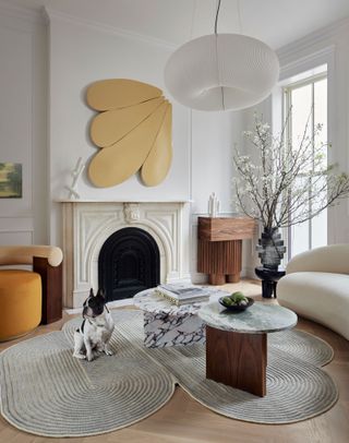 a series of marble coffee tables in a modern living room with decorative art on the walls