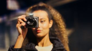 Woman holding Lumix TZ300 zoom camera