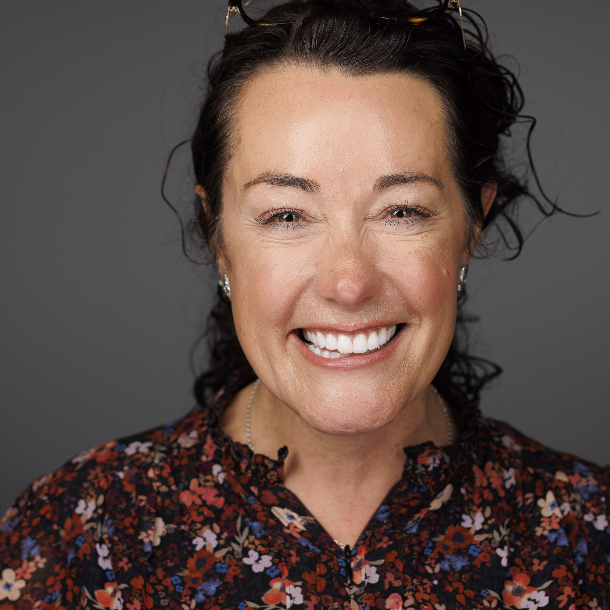 A headshot of photographer Ellie Rothnie in a studio