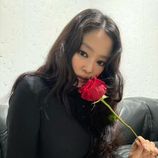 Photo of Jennie Kim holding a rose