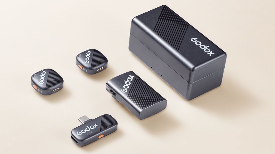 The Godox Cube-C wireless mic sits on a tan background