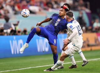 Weston McKennie of USA controls the ball under pressure from Mason Mount and Mason Mount of England during the FIFA World Cup Qatar 2022 Group B match between England and USA at Al Bayt Stadium on November 25, 2022 in Al Khor, Qatar.