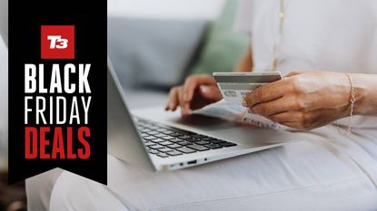 Woman using a credit card to shop online in the Black Friday sales