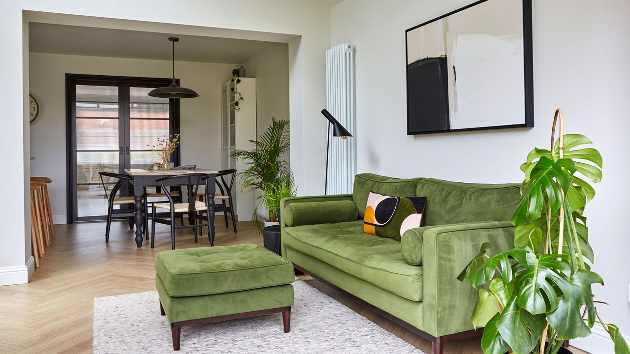 Living area in open-plan extension with green sofa and footstool