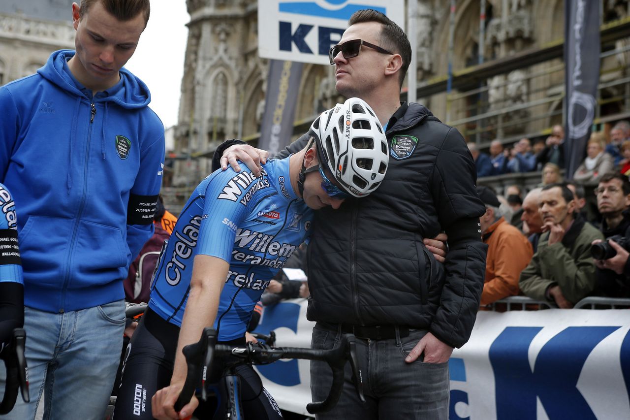 DS Nick Nuyens comforts a rider mourning Michael Goolaerts