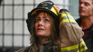 Diane Farr holding her helmet up in Season 2 of Fire Country.