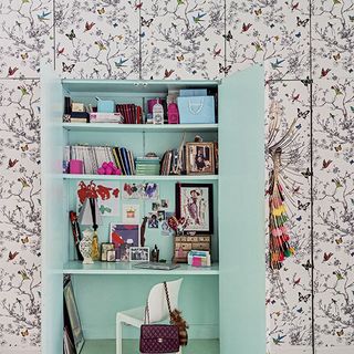 hidden room with floral wallpaper and cupboard