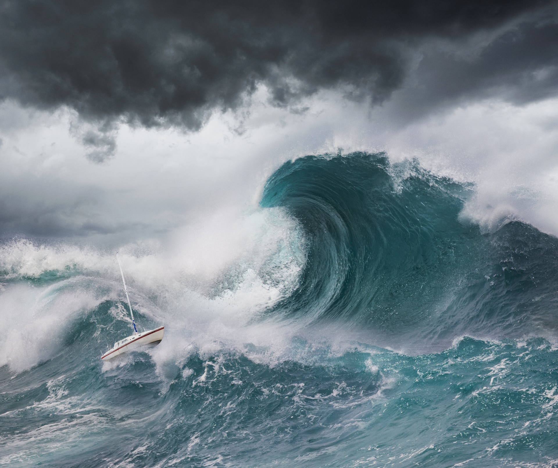 A photo illustration of a small sailboat facing a tsunami wave