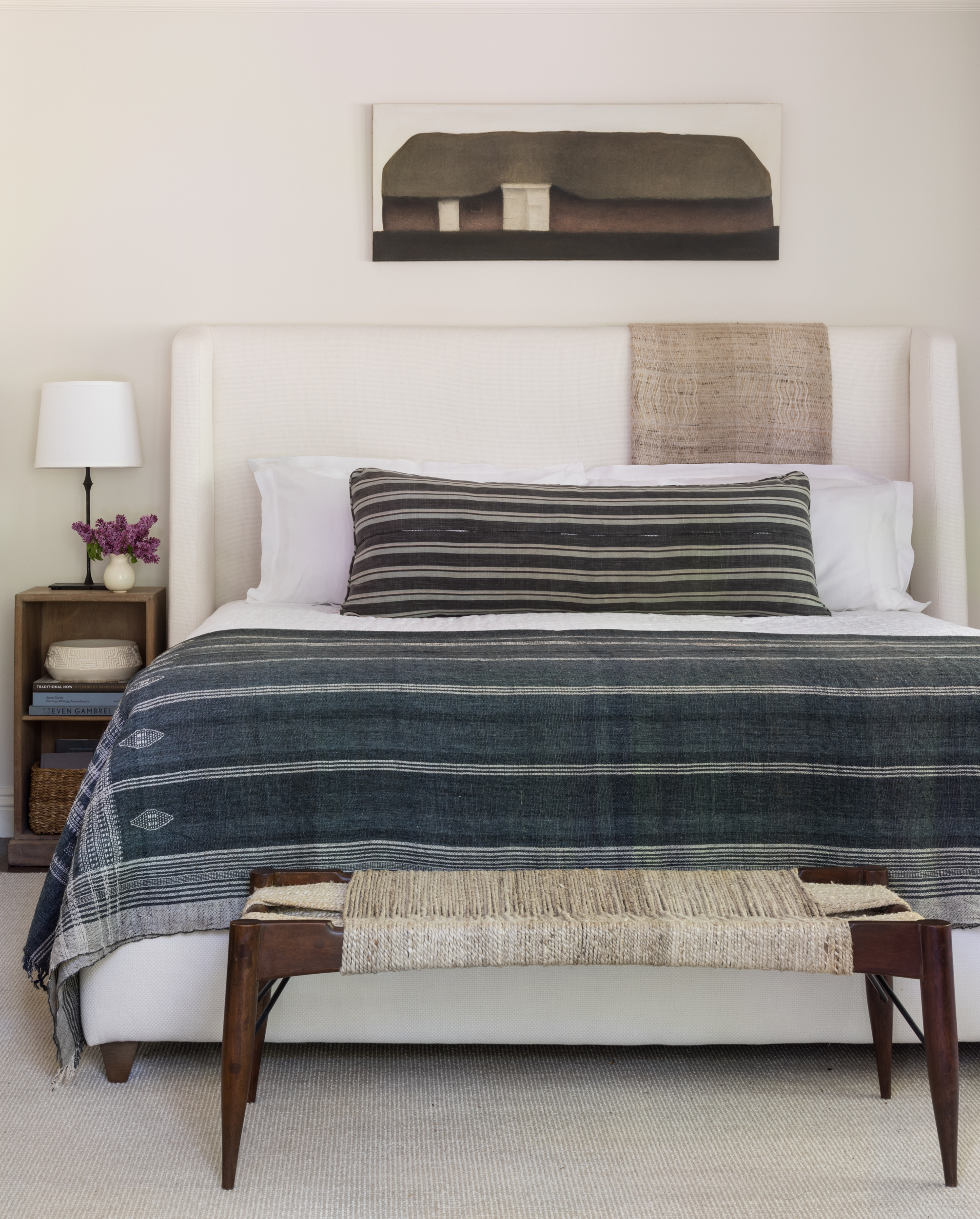 neutral bedroom with striped cushion and throw