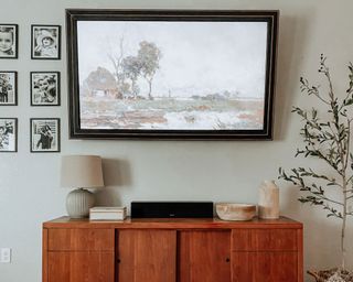 frame tv and tv unit with black and white family photographs