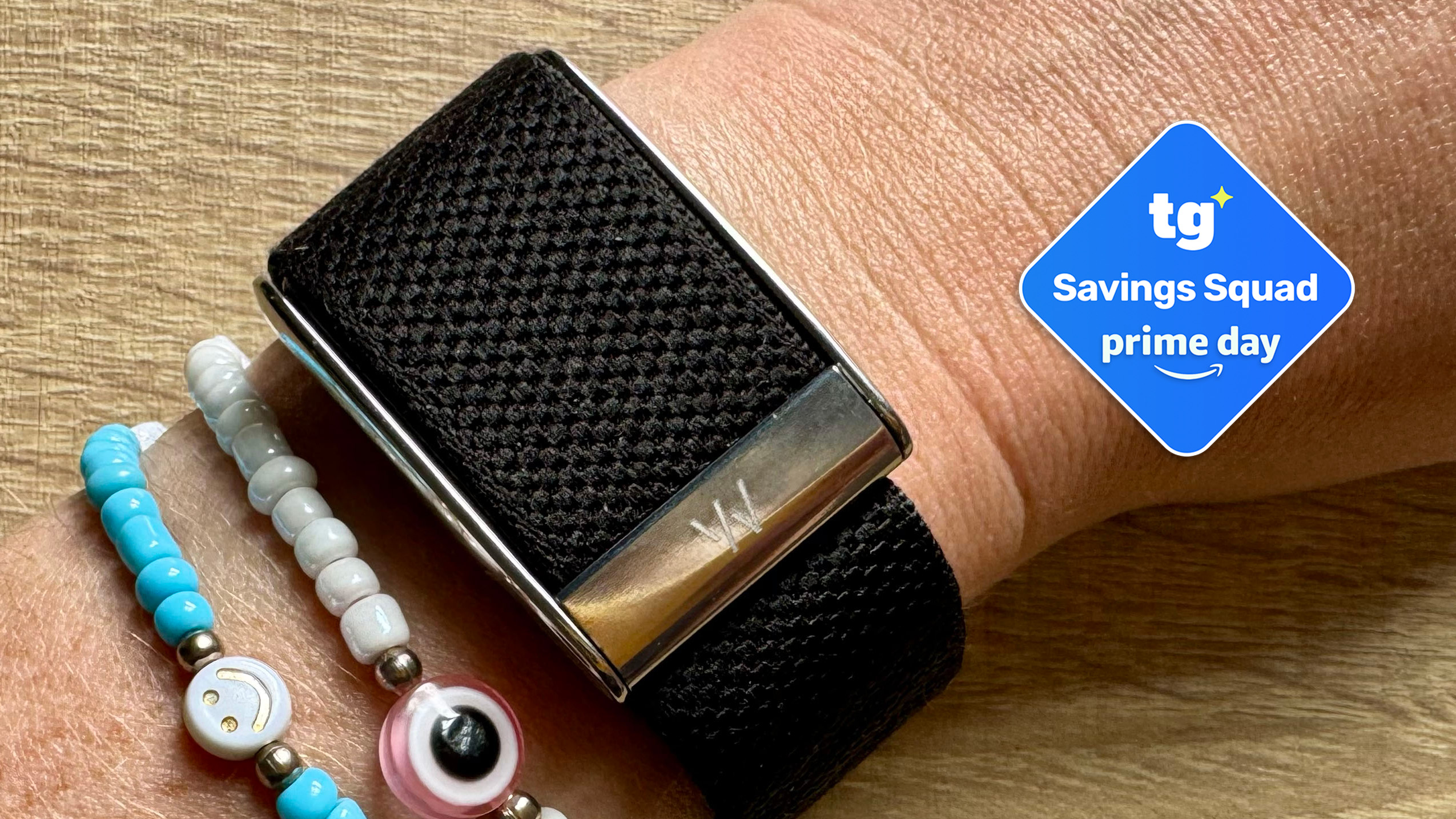 Whoop band on wearers wrist with savings squad badge