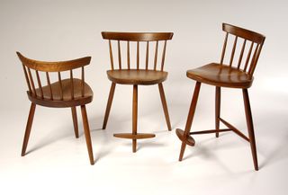 Three brown Mira Nakashima chairs